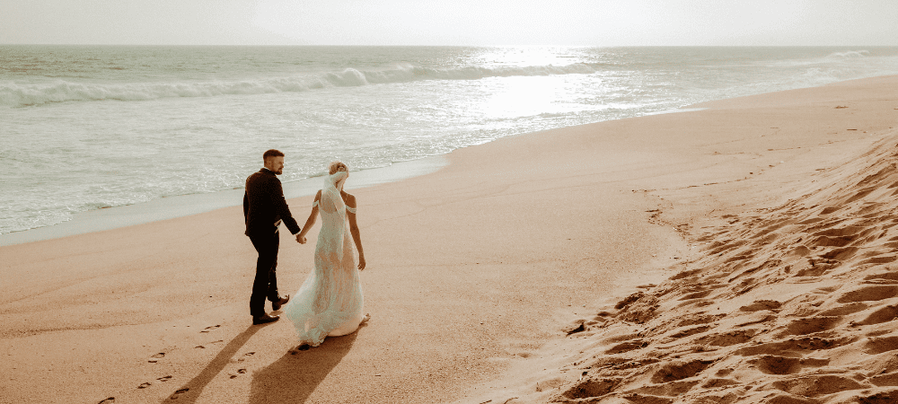 married couple walking on the Los Cabos beach