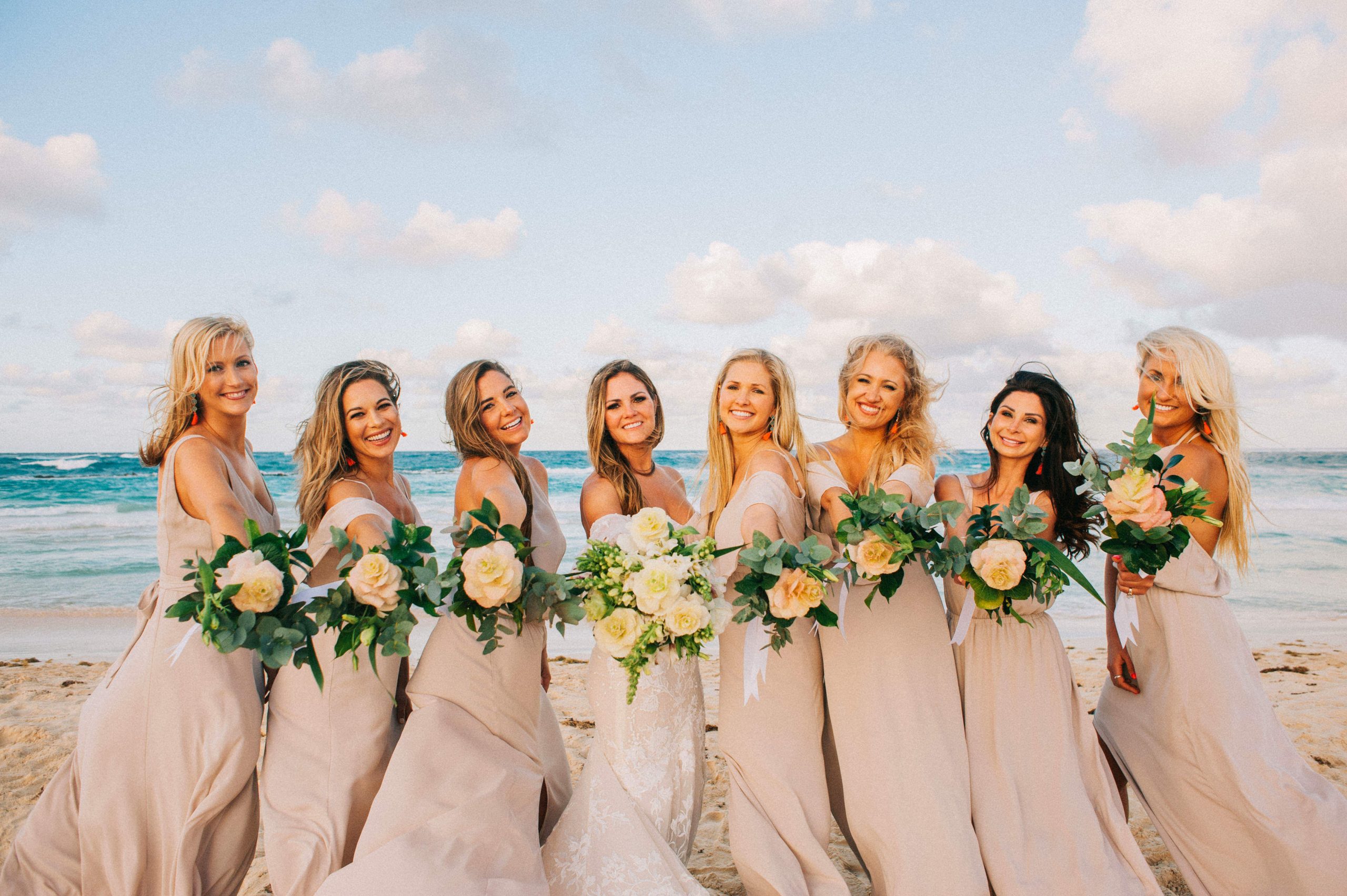 wedding maids with floral arrangements