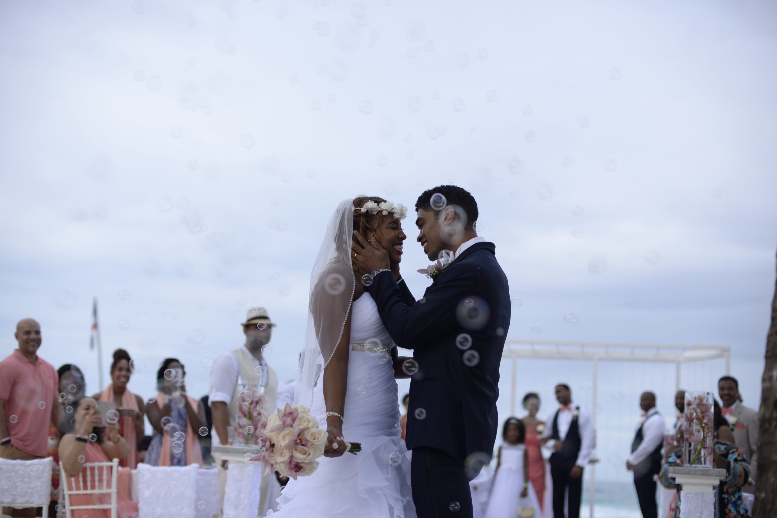 couple embracing during beach wedding reception