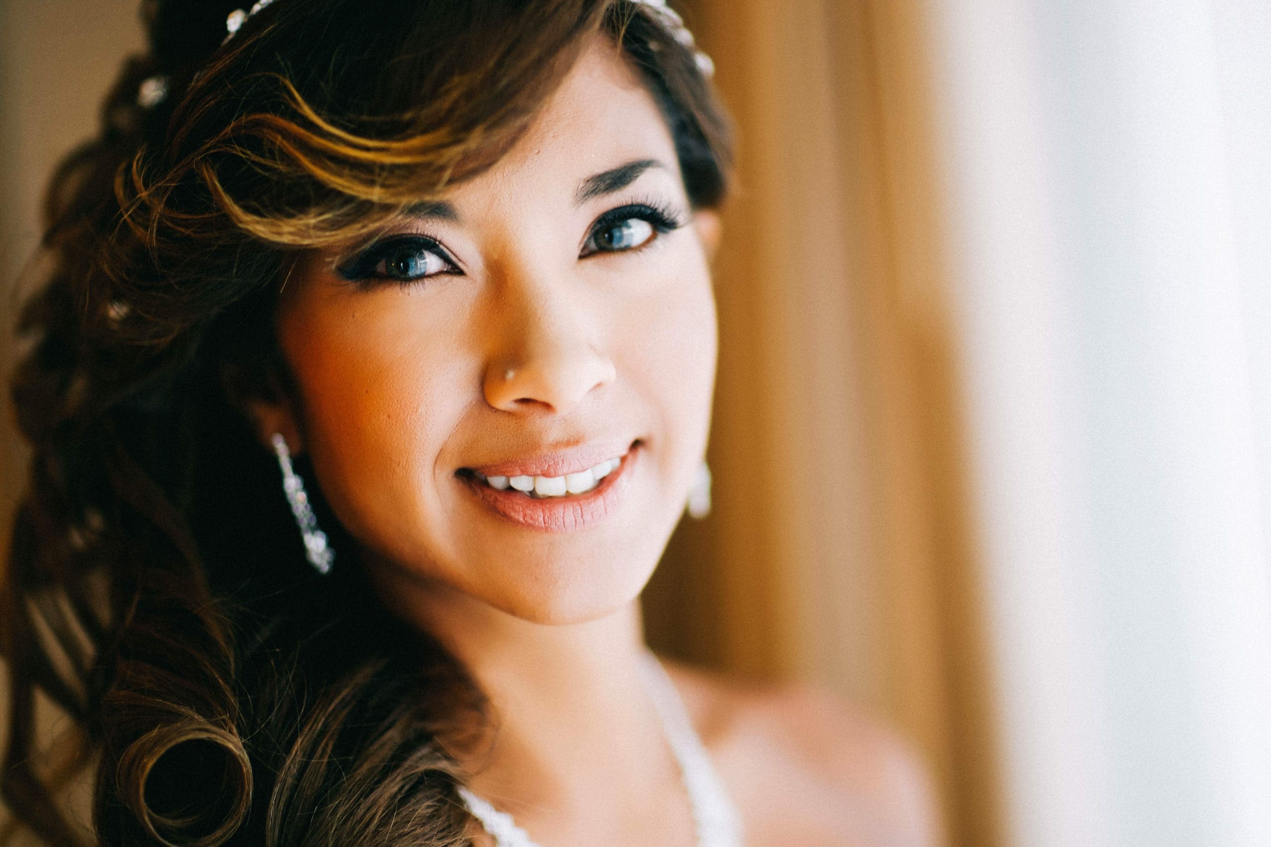 lovely bride looking into the camera while taking some getting ready shots for her beach wedding