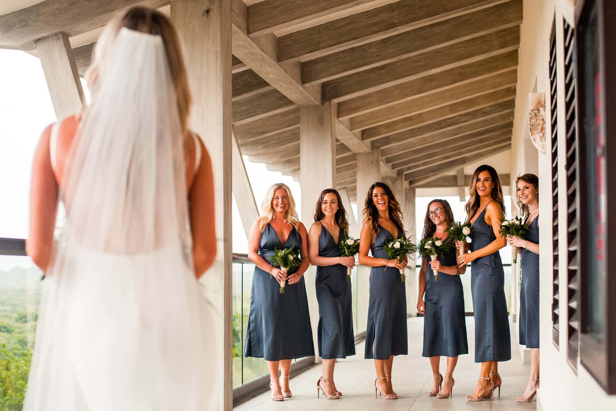 bride's first look with her excited bridesmaids before the ceremony 