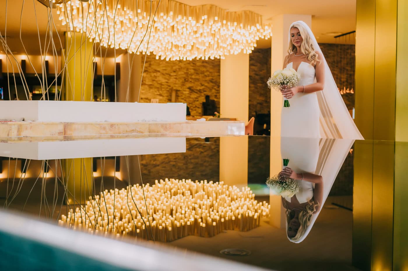 Evelyn posing with wedding dress at reflective fountain at Palladium Resort