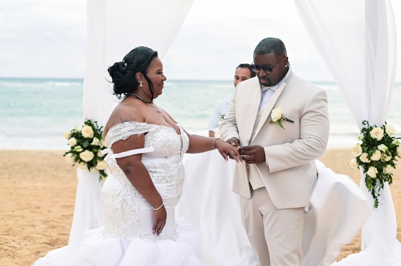 Wedding ceremony on Punta Cana beach with couple exchanging vows.