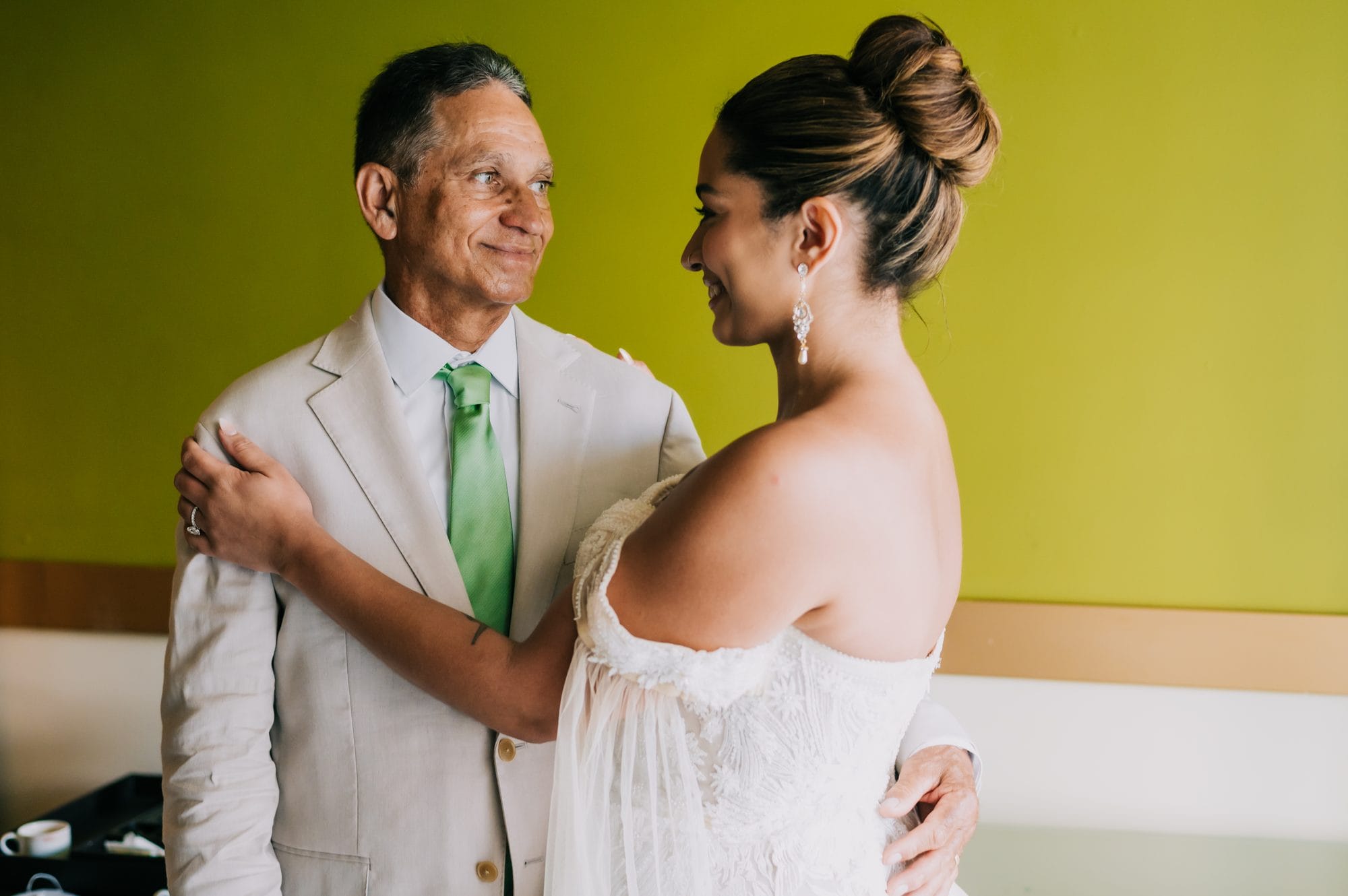 Tender moment between the bride and her father during getting-ready at Dreams Onyx
