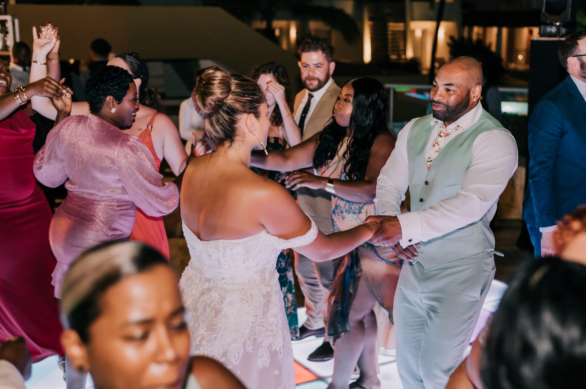 Bride and groom dancing with their guests during the reception at Dreams Onyx in Punta Cana