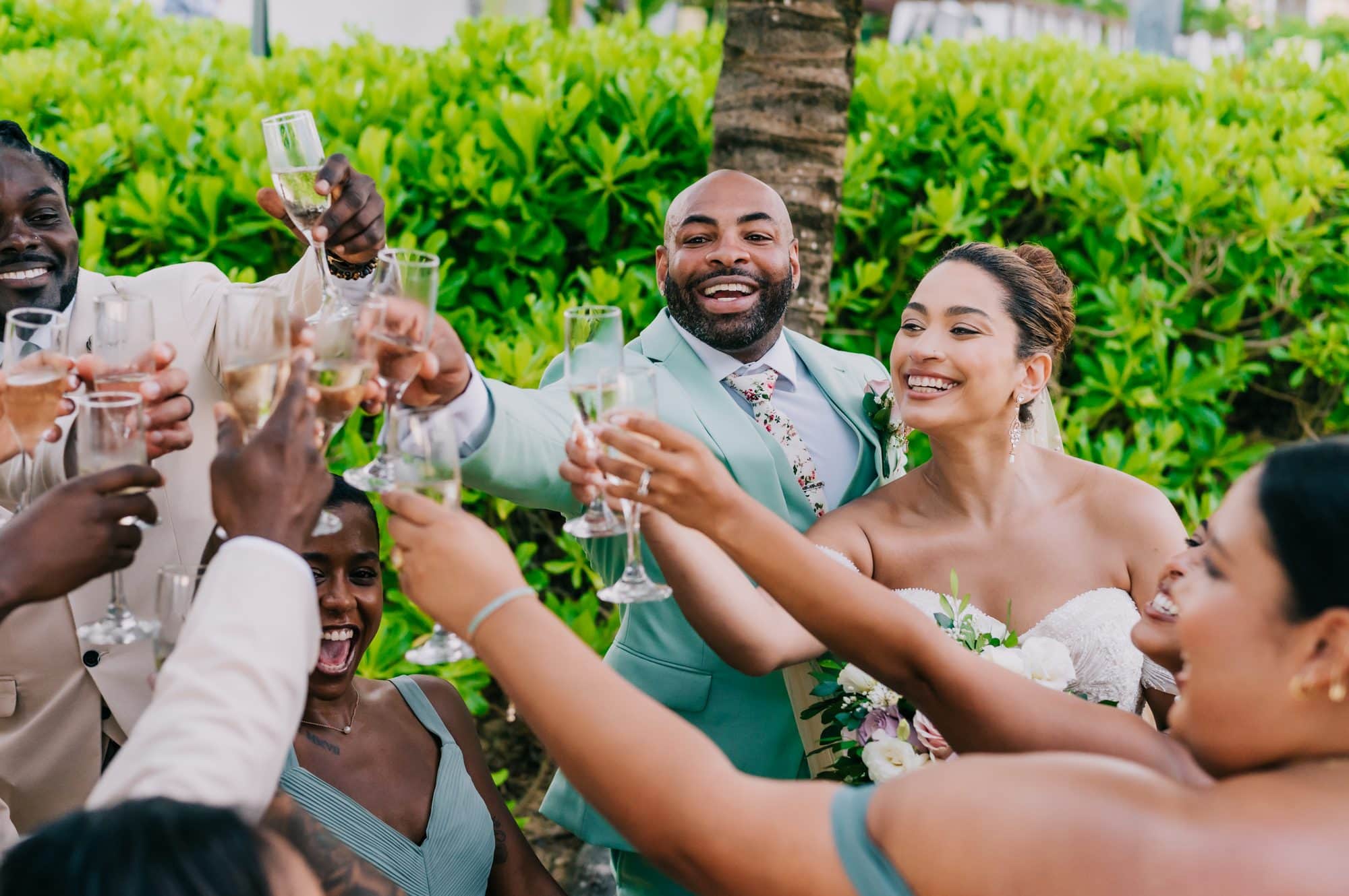 Bride, groom and wedding party raising a champagne toast after the ceremony at Dreams Onyx