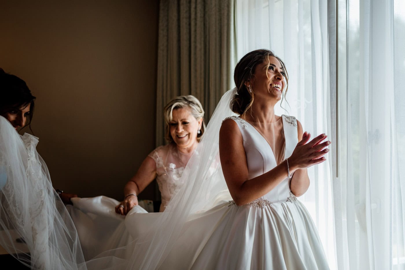 A bride gets ready with family at a Punta Cana resort, an essential preparation stage in a well-planned destination wedding day timeline.
