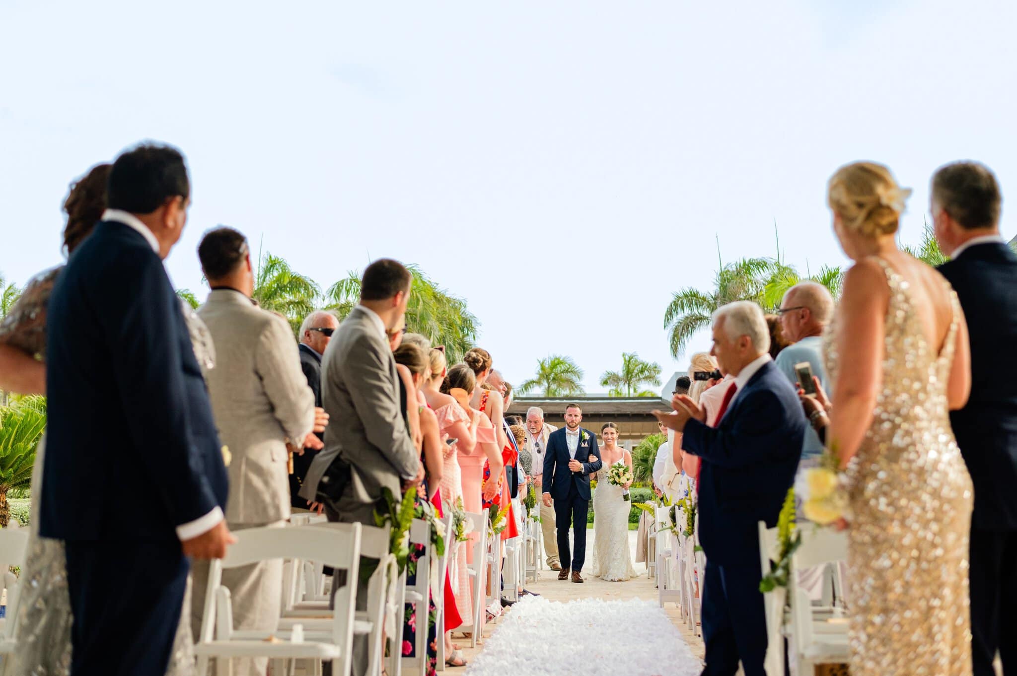 Bride escorted down the aisle by her brother at a Punta Cana resort wedding