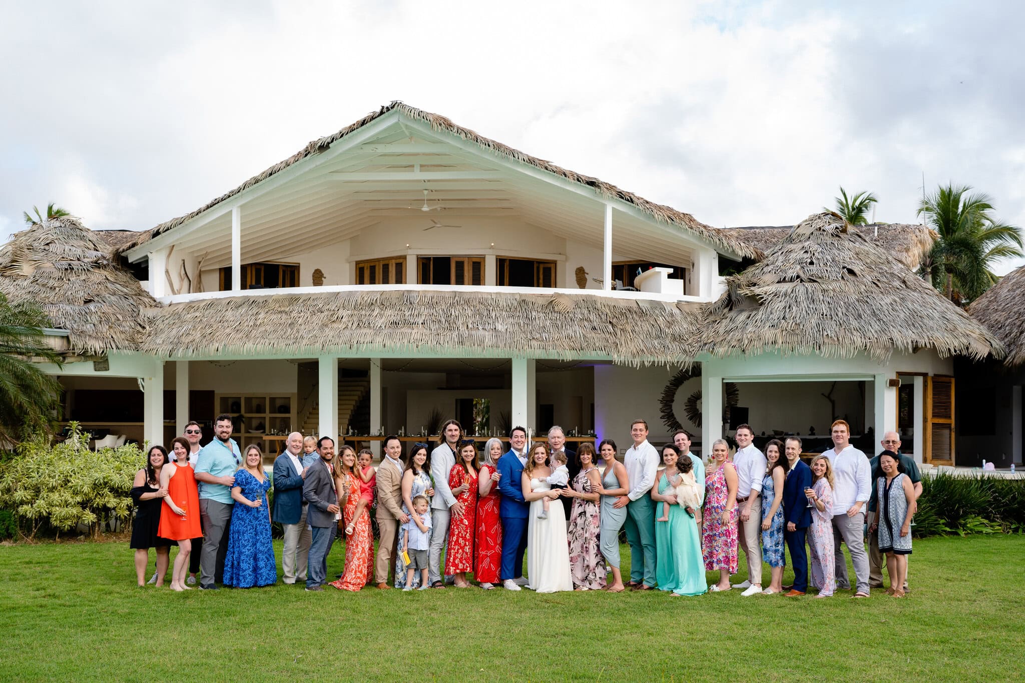 Extended family and guests gathered for a group photo at a destination wedding