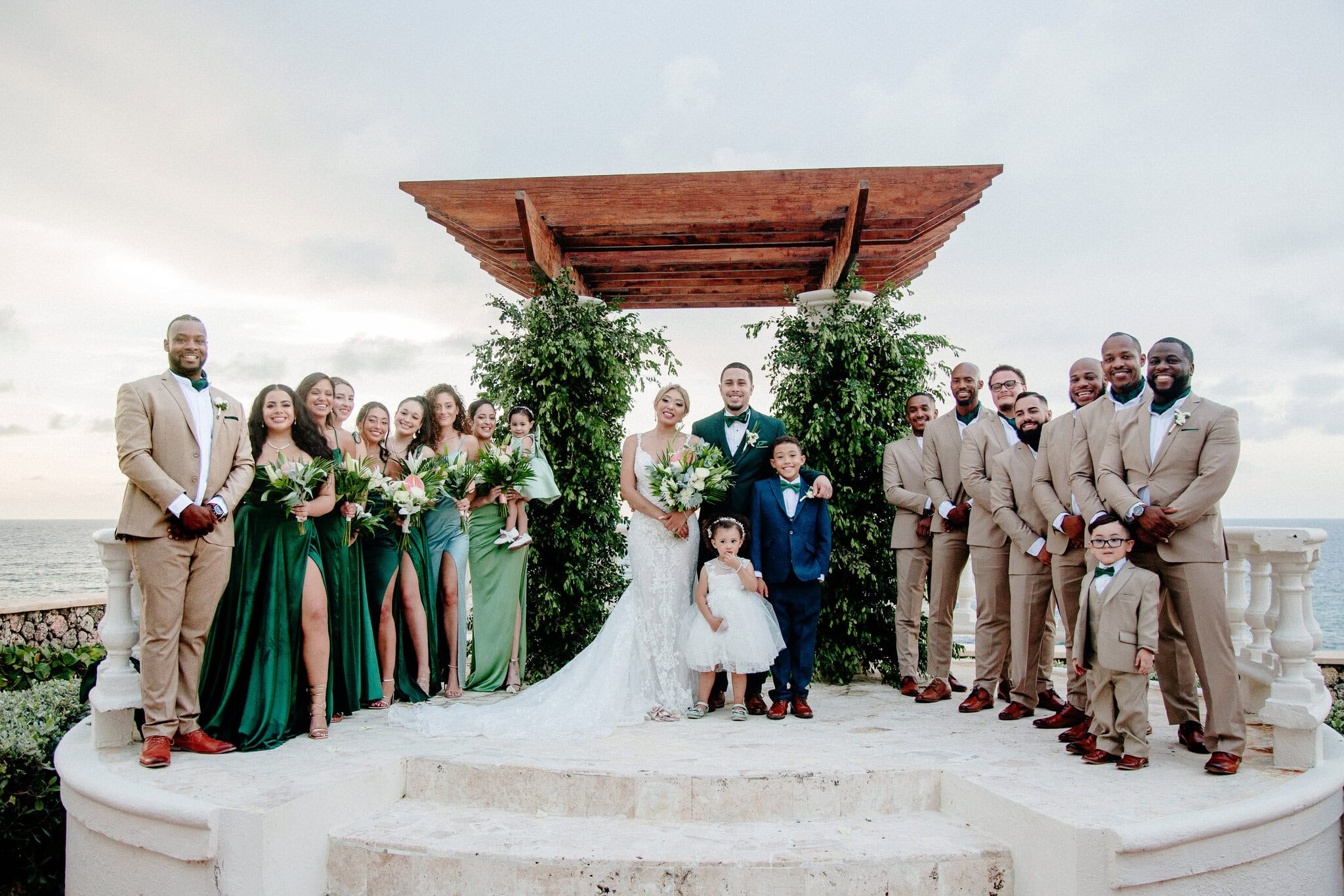 Full wedding party posing together for a group photo at a destination wedding