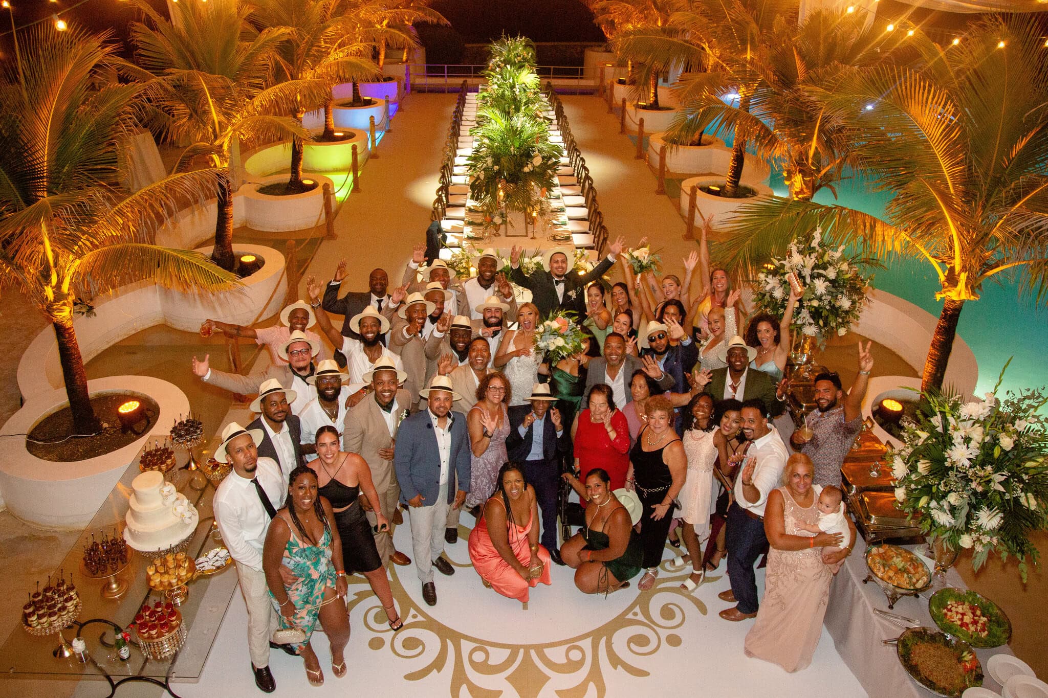 Large group photo of all wedding guests at a destination wedding reception