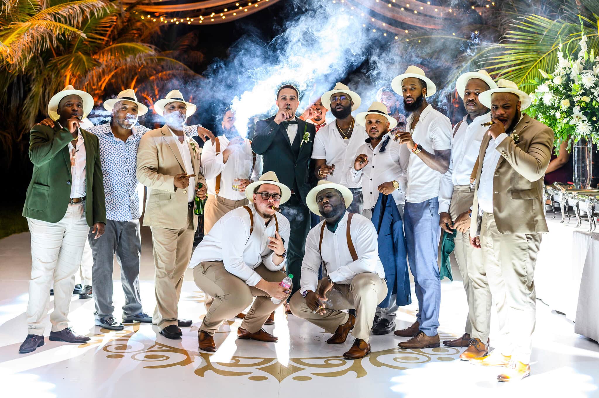 Groom celebrating with friends during a destination wedding reception