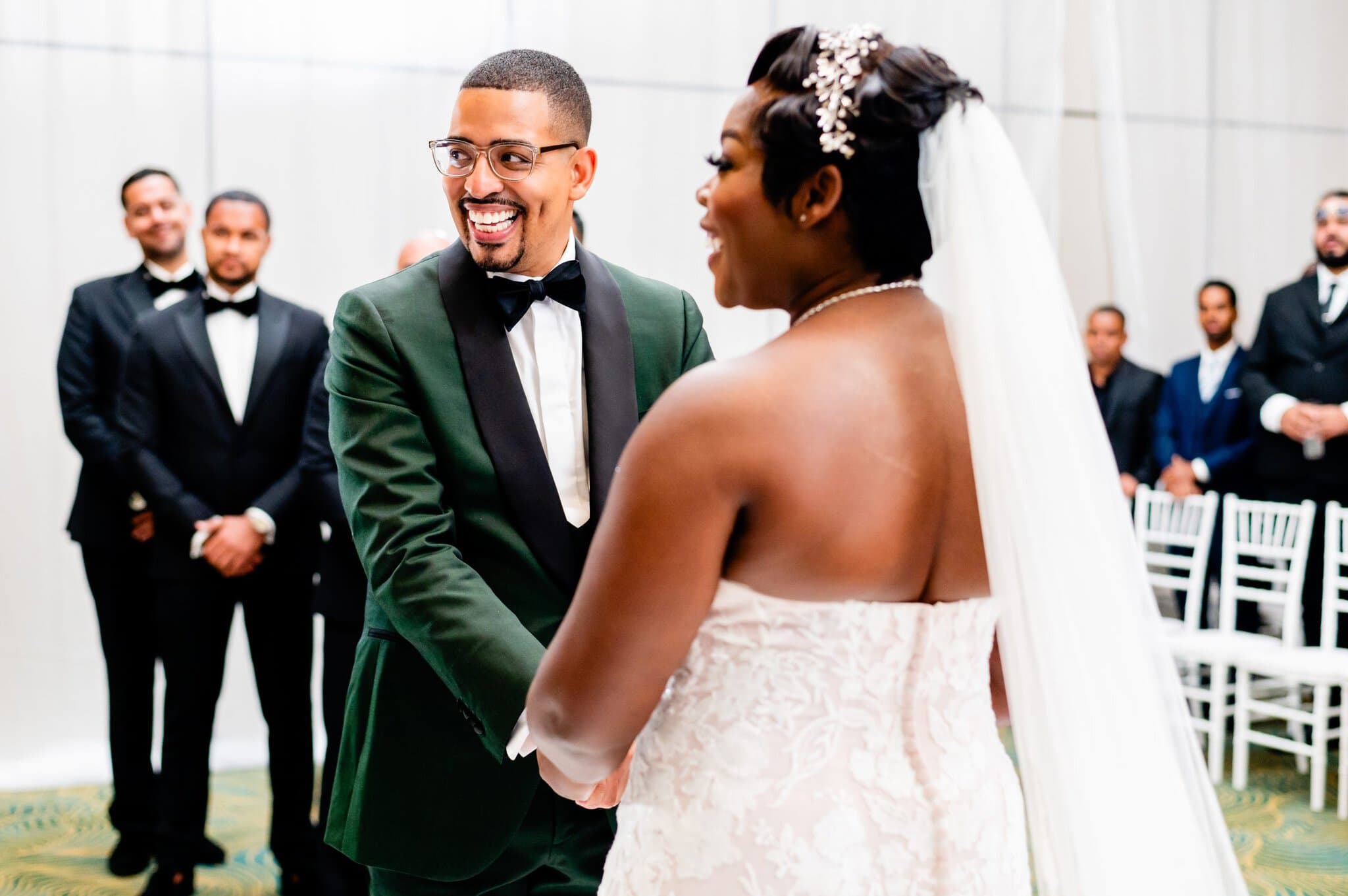 Bride and groom holding hands during their indoor wedding ceremony at Dreams Macao Punta Cana