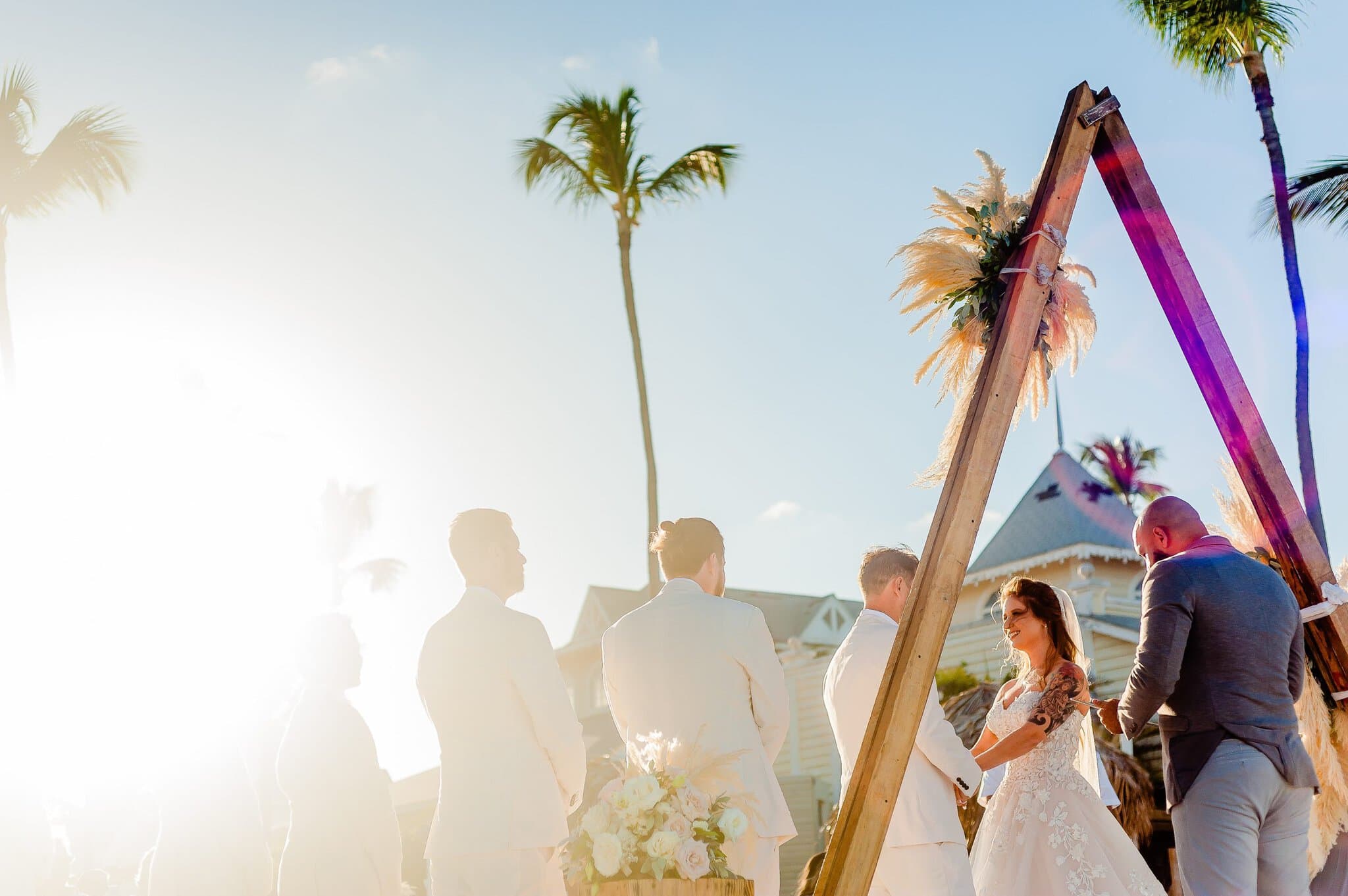 Beach wedding ceremony with a pampas grass arch in Punta Cana