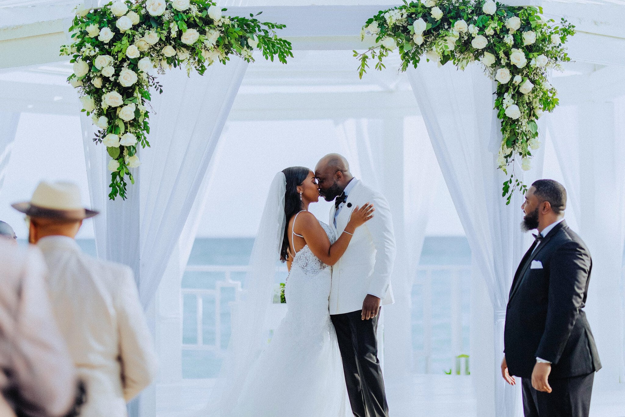 Bride and groom share their first kiss at an oceanfront gazebo ceremony in Punta Cana