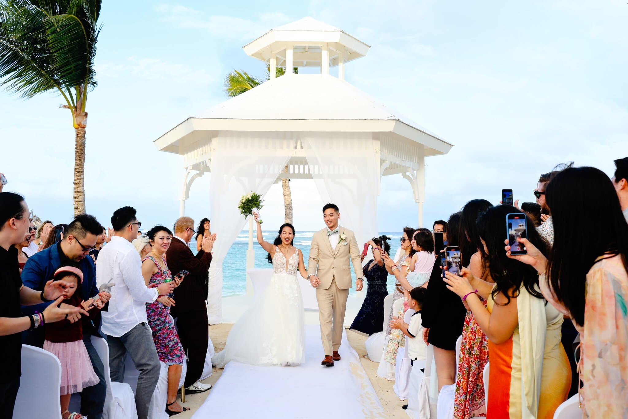 Bride and groom celebrating at their gazebo wedding ceremony in Punta Cana