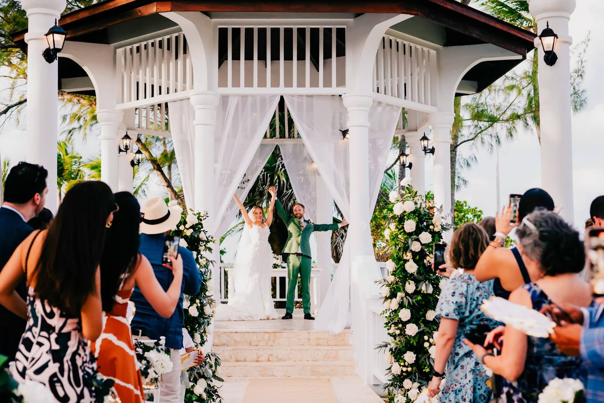 Newlyweds celebrating with guests at a gazebo wedding ceremony in Punta Cana