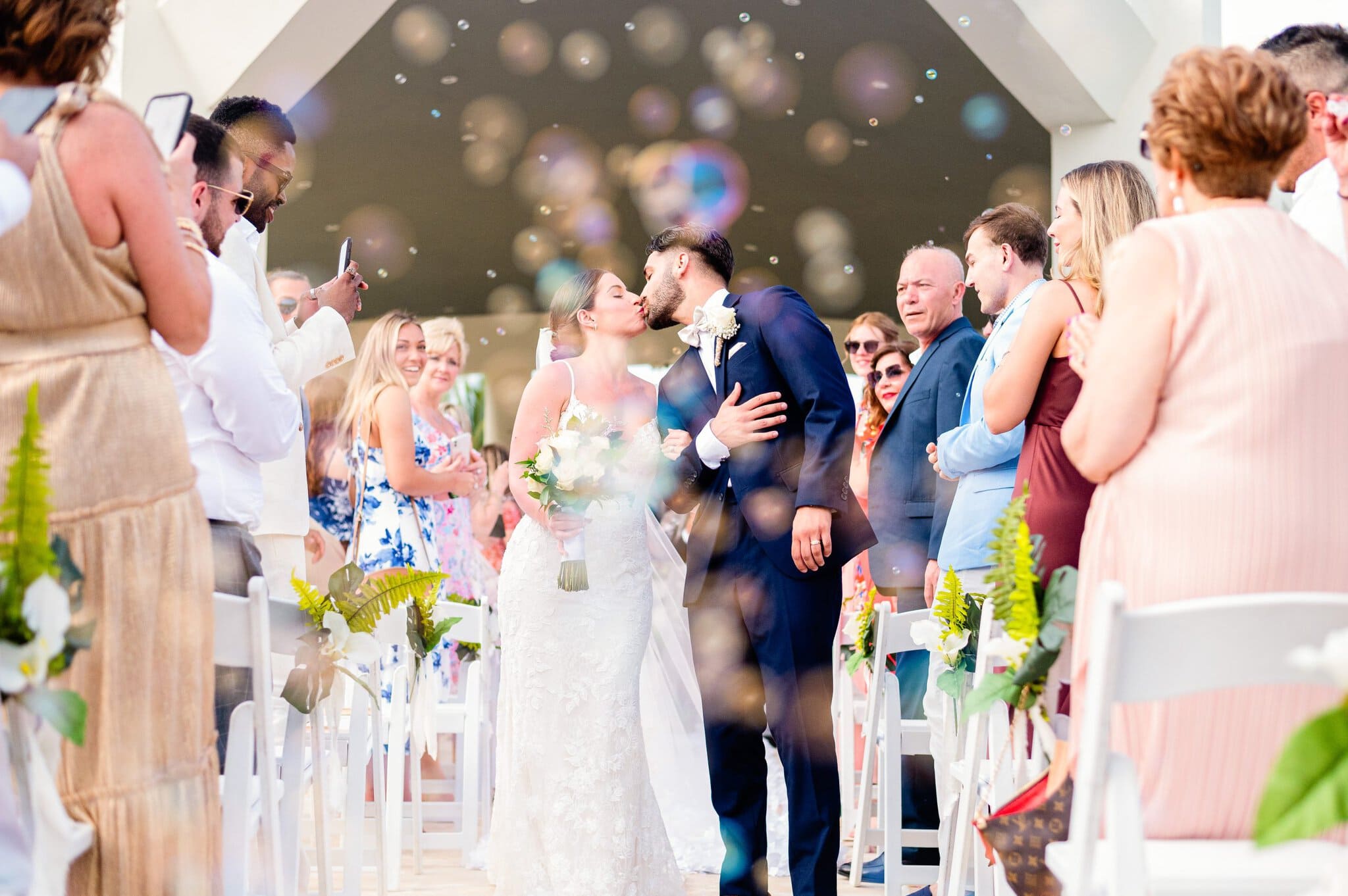 Couple's first kiss surrounded by bubbles at a Punta Cana wedding ceremony
