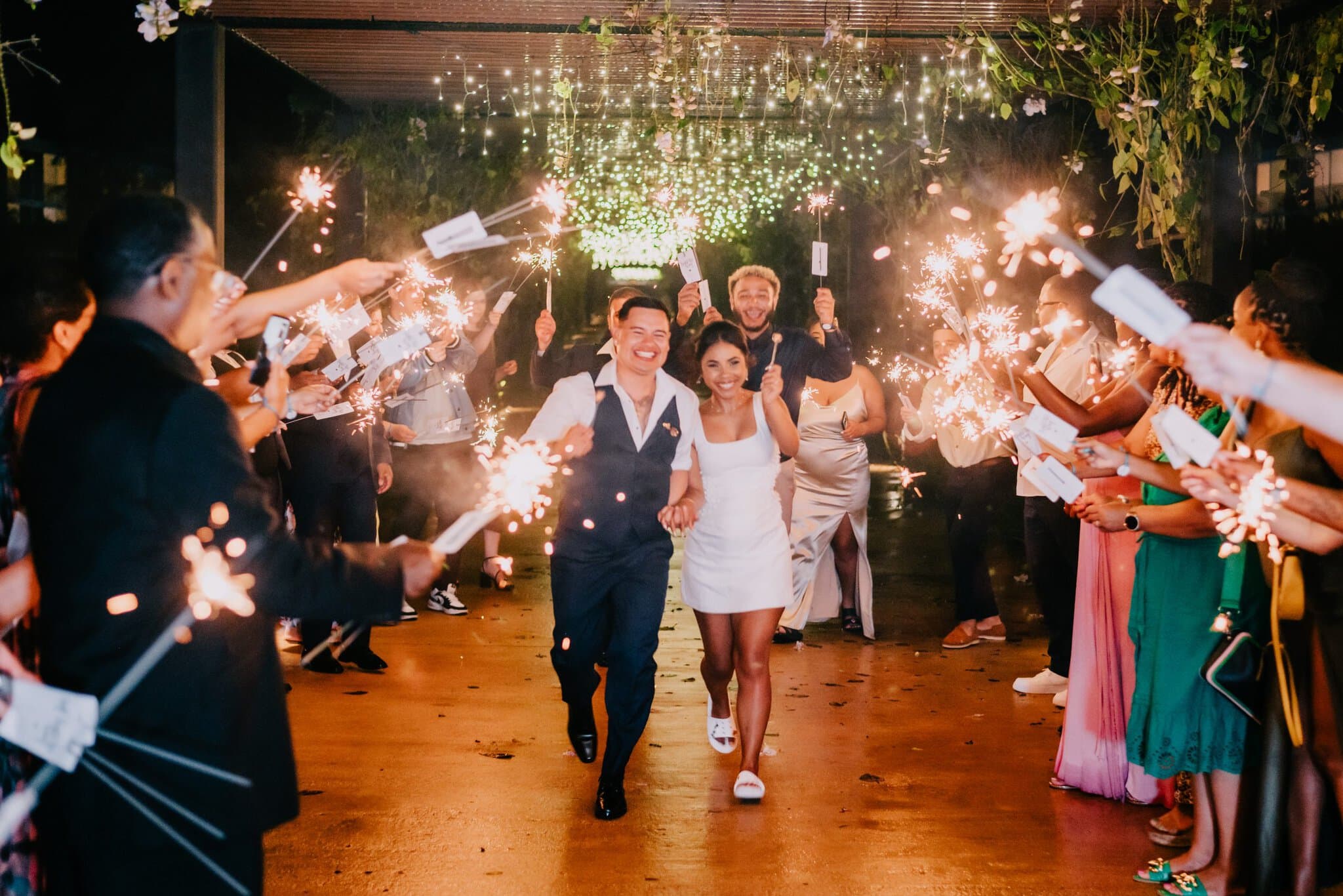 Newlyweds walking through a sparkler send-off at a Punta Cana wedding