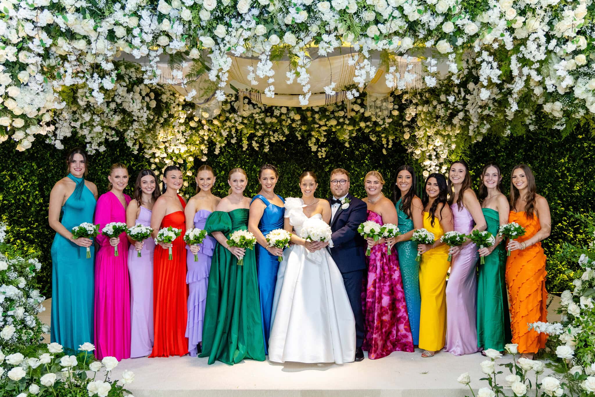 Bride and groom with bridal party under a floral arch at The Westin Punta Cana