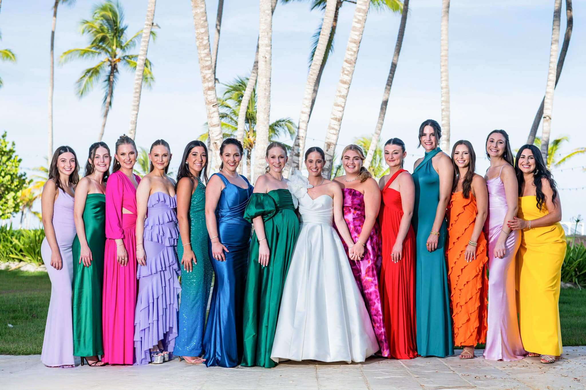 Bride with bridesmaids in colorful dresses under the sun at The Westin Punta Cana