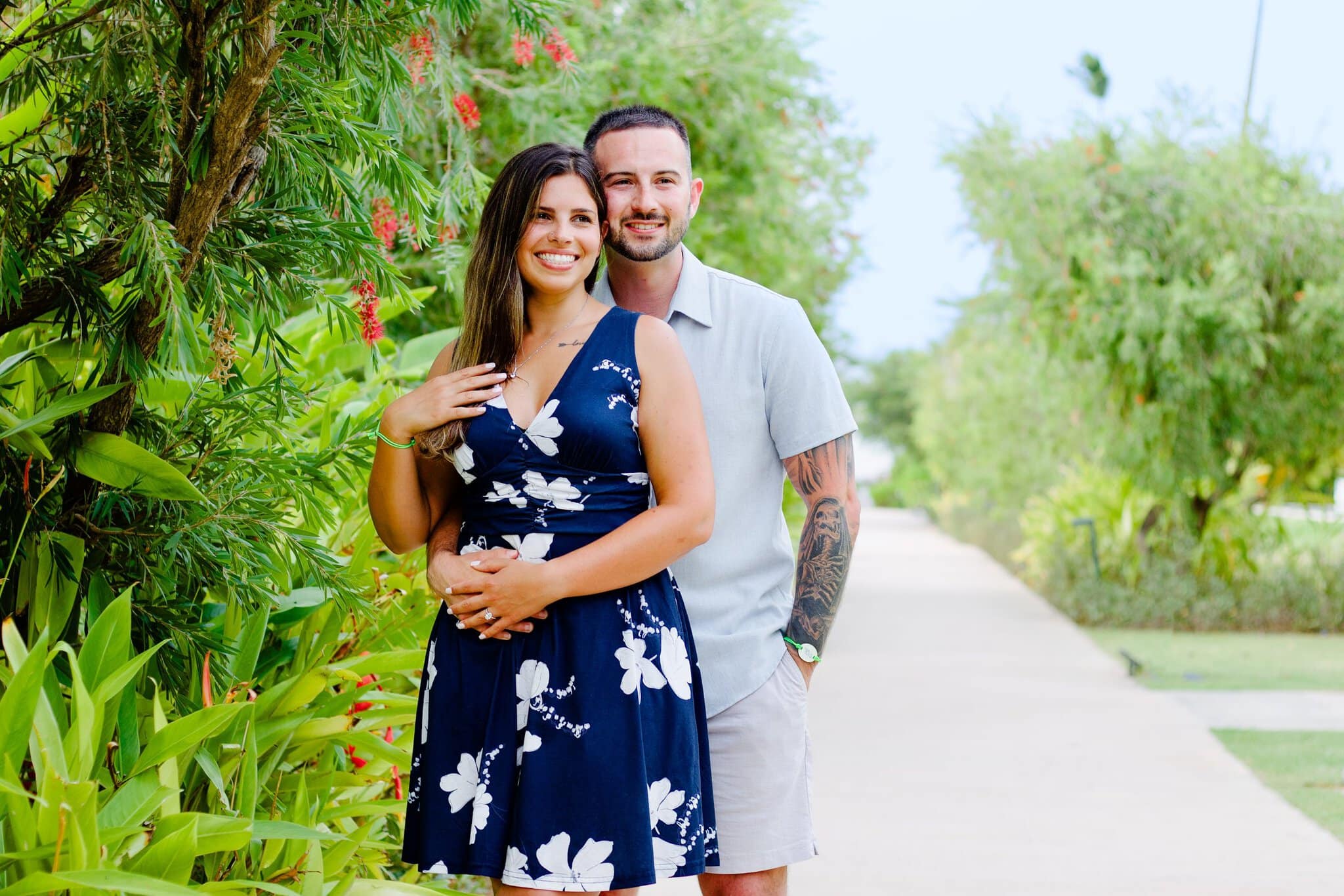 Newly engaged couple embracing among tropical plants at Live Aqua Punta Cana