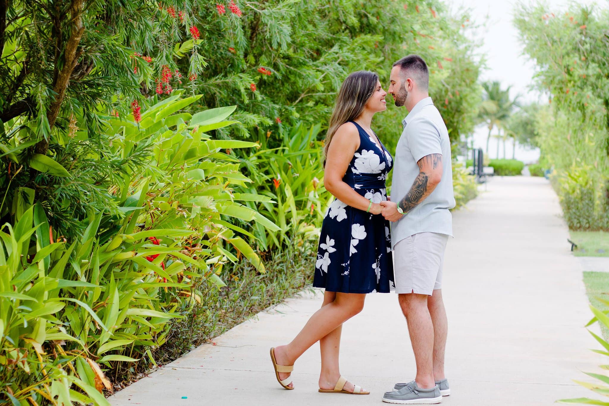 Couple facing each other on a lush garden path in Punta Cana