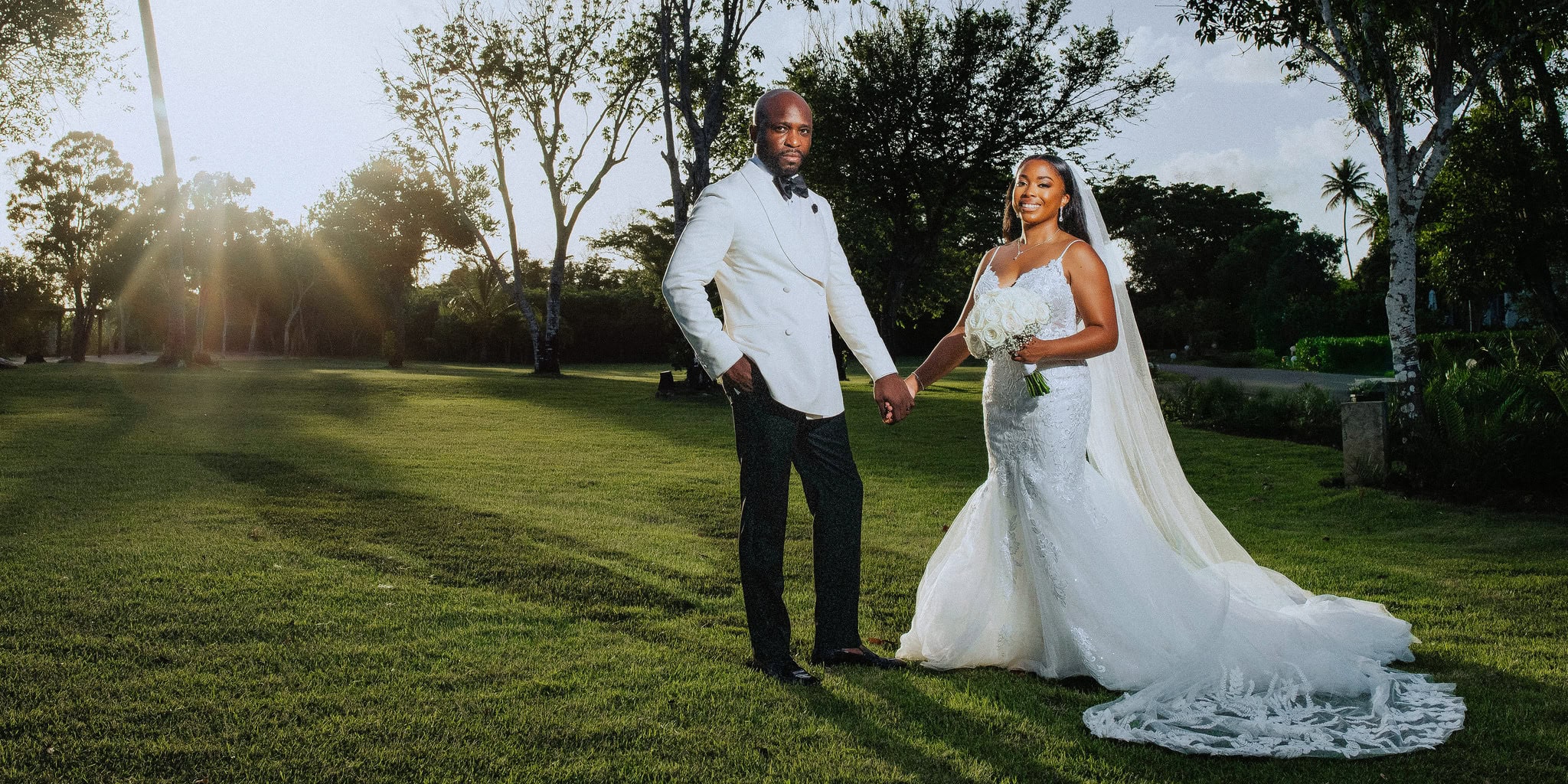 Bride and groom holding hands on the lawn at sunset after their wedding in Bayahibe, Dominican Republic