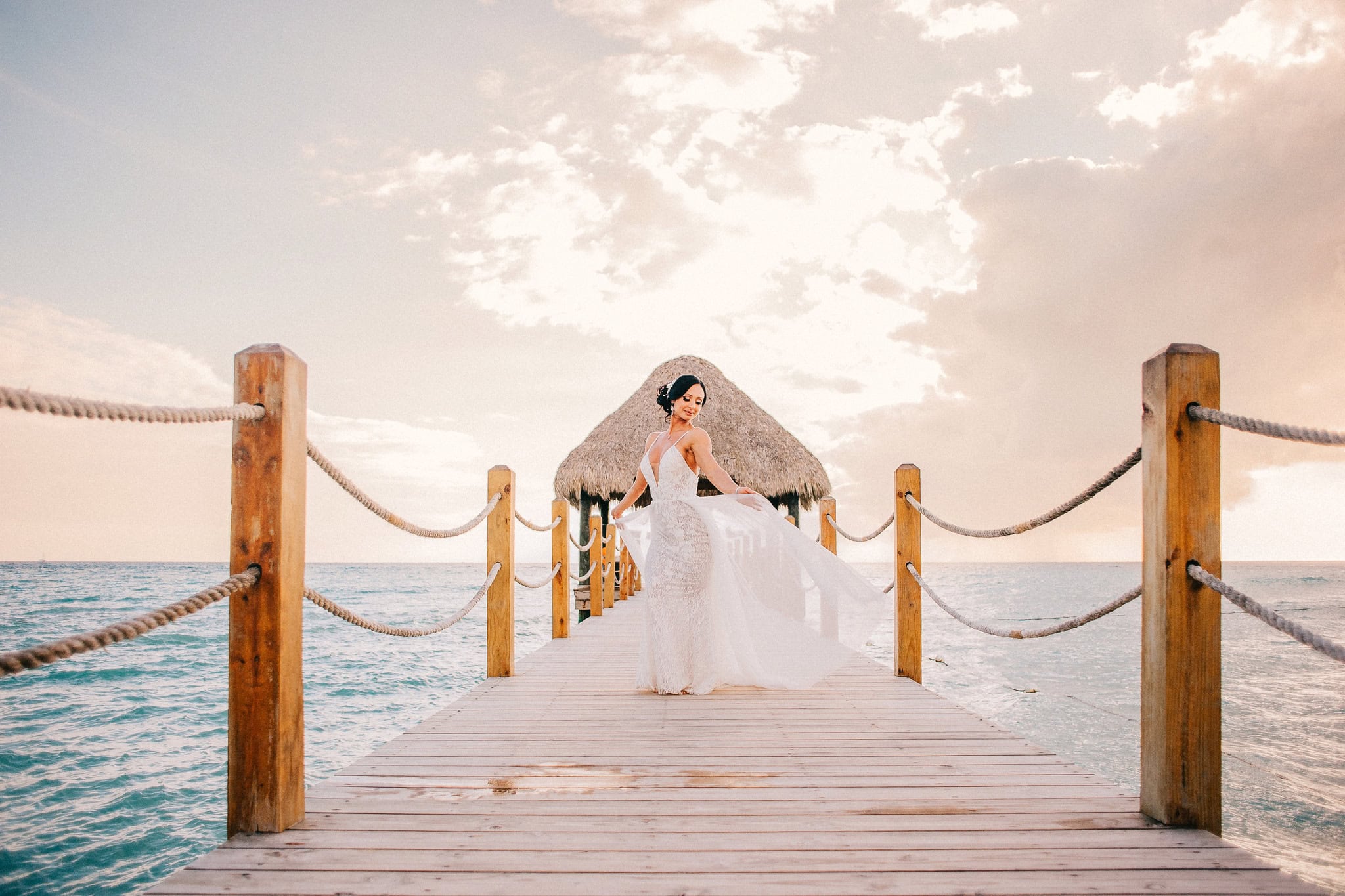Bride on the ocean pier wedding platform at Dreams Dominicus La Romana in Bayahibe, Dominican Republic