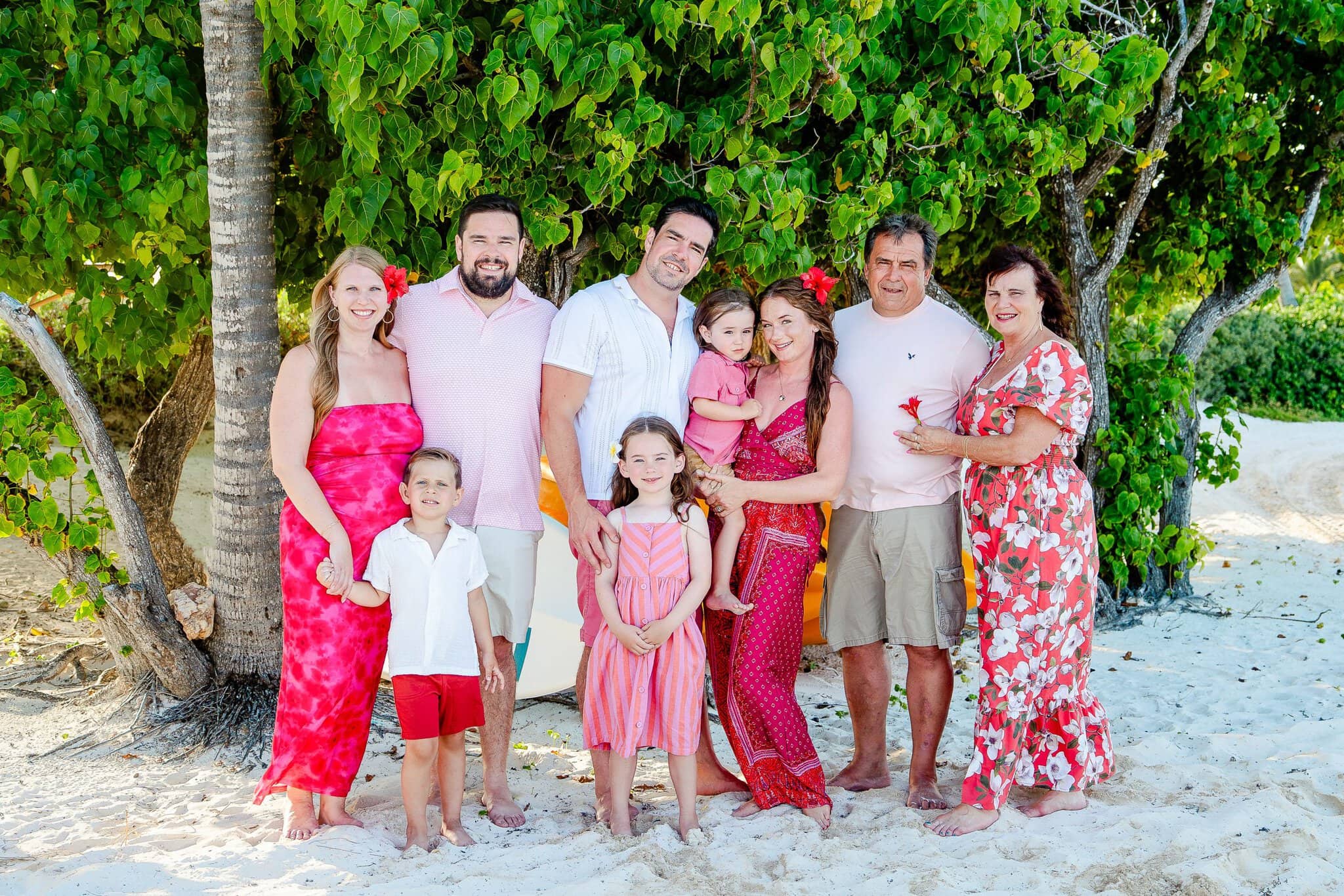 Multi-generational family posing together on the beach during an extended family photo session