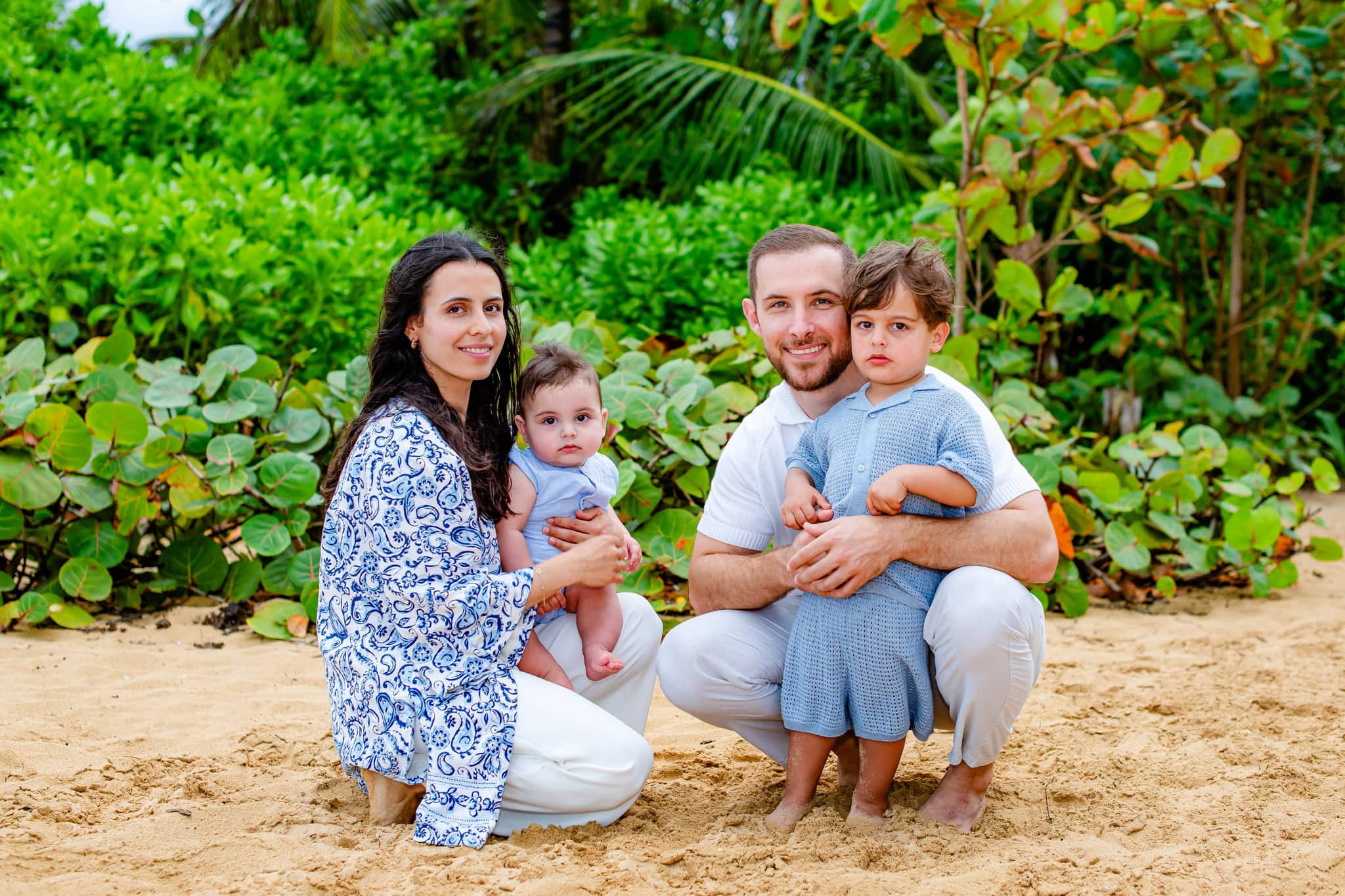 Grandmother and her grandchildren playing behind a palm tree during a family session in Punta Cana