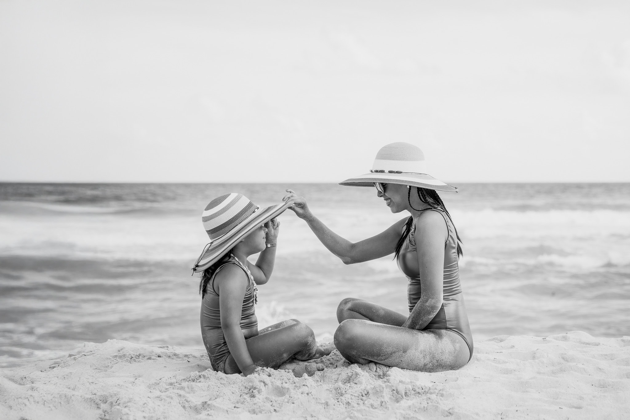 Mother and daughter sharing a moment on the beach in Punta Cana, black and white photo