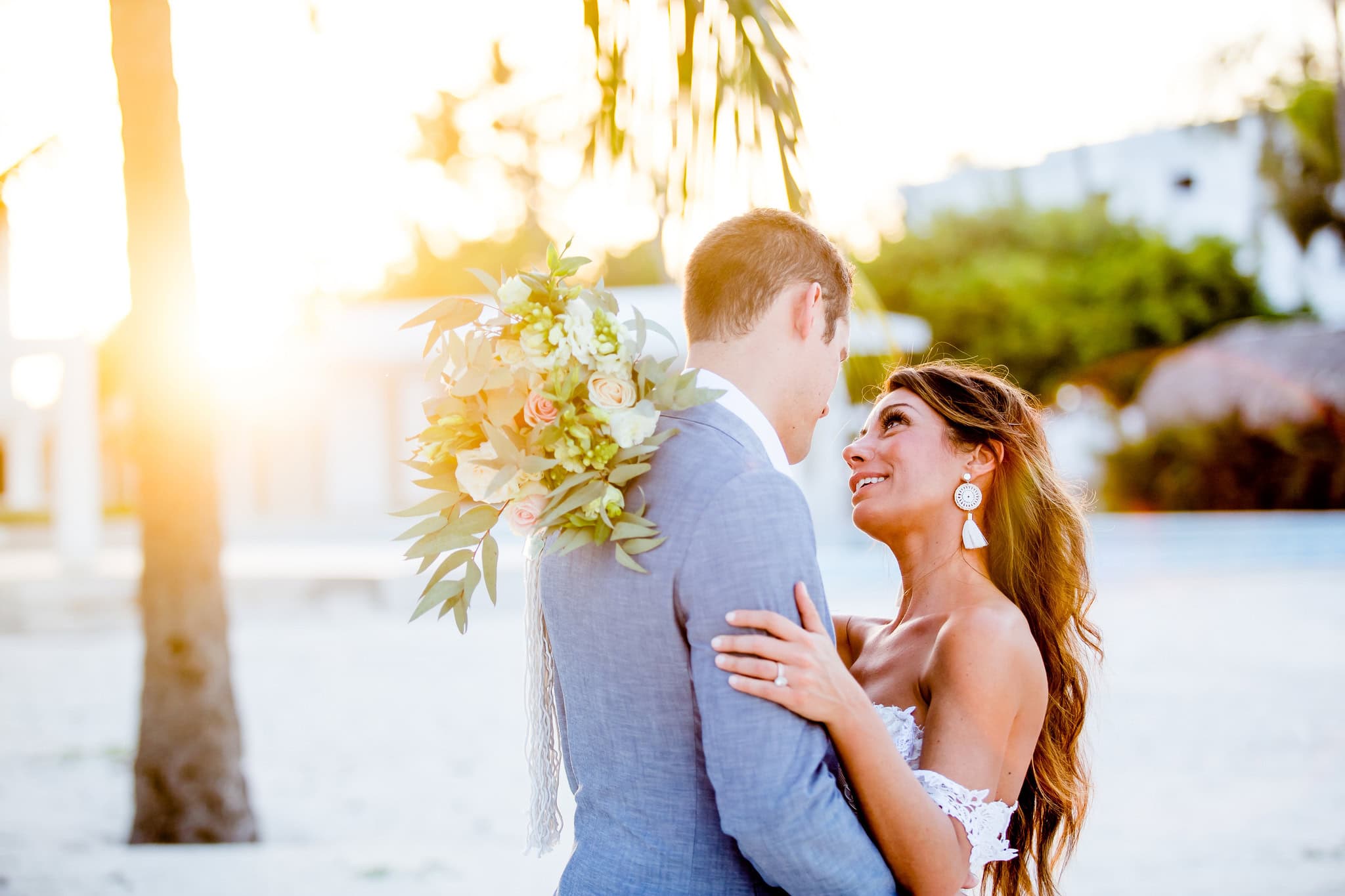 Bride and groom embracing on the beach in the last light of the day at a Punta Cana wedding